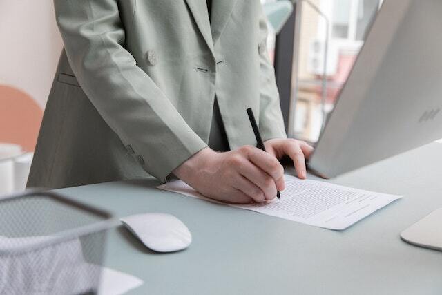 singing a pleasanton property management contract at a desk in front of a computer